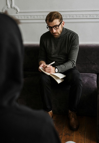 Picture of man writing on notebook