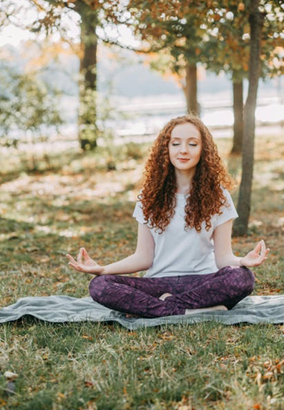Picture of woman meditating in park